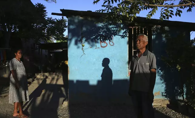 A man stands in front of his house in Dili, East Timor, Friday, Sept. 6, 2024. (AP Photo/Firdia Lisnawati)