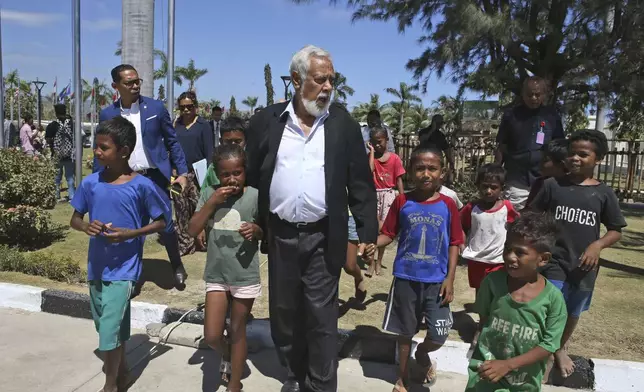 East Timor Prime Minister Xanana Gusmão walks with children in Dili, East Timor, Thursday, Sept. 5, 2024. (AP Photo/Firdia Lisnawati)