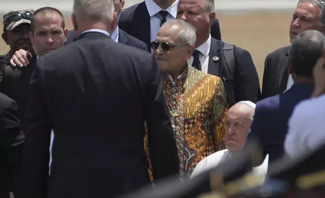 Pope Francis is accompanied by East Timor's President Jose Ramos-Horta to abroad a plane to Singapore at Nicolau Lobato International Airport in Dili, East Timor, Wednesday, Sept. 11, 2024. (AP Photo/Dita Alangkara)