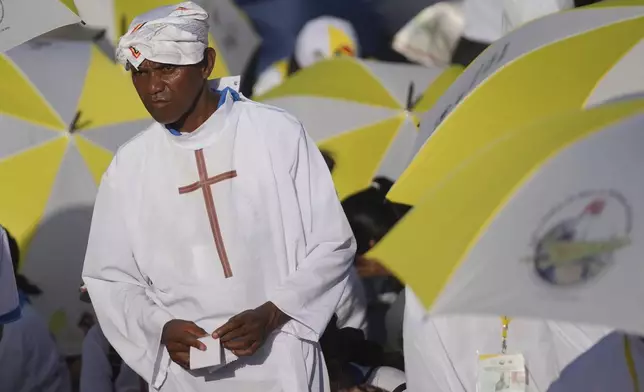 A faithful attends the holy mass lead by Pope Francis at Tasitolu park in Dili, East Timor, Tuesday, Sept. 10, 2024. (AP Photo/Dita Alangkara, Pool)