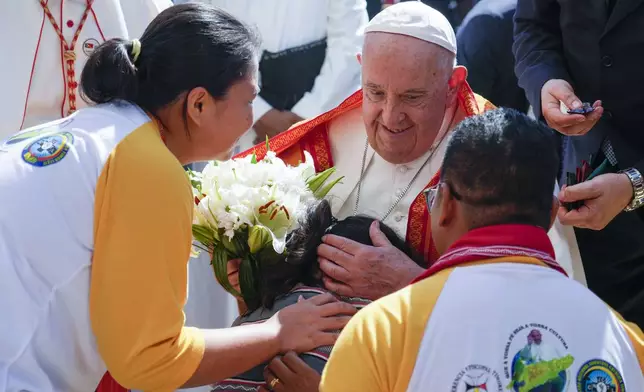 Pope Francis is welcomed as he arrives at the Centro de Convenções in Díli, East Timor, Wednesday, Sept. 11, 2024, for a meeting with young people. The Vatican says some 600,000 people have attended Pope Francis' Mass in East Timor, or nearly half the country's population, on Tuesday on the same field where St. John Paul II prayed in 1989 during the nation's fight for independence from Indonesia. (AP Photo/Gregorio Borgia)