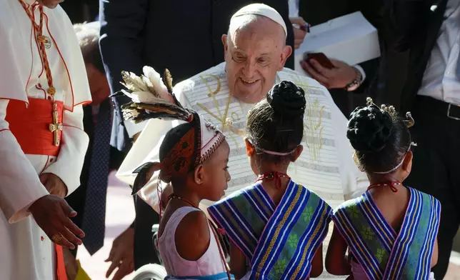 Pope Francis arrives at the 'Irmas ALMA' (Sisters of the Association of Lay Missionaries) School for Children with Disabilities in Dili, East Timor, Tuesday, Sept. 10, 2024. Pope Francis has indirectly acknowledged the abuse scandal in East Timor involving its Nobel Peace Prize-winning independence hero Bishop Carlos Filipe Ximenes Belo. "Let us also not forget that these children and adolescents have their dignity violated," Francis said. "In response, we are all called to do everything possible to prevent every kind of abuse and guarantee a healthy and peaceful childhood for all young people." (AP Photo/Gregorio Borgia)