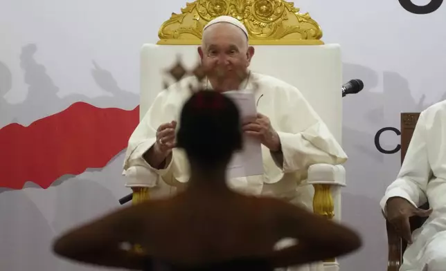 Pope Francis looks at traditional dancers as he arrives at the Centro de Convenções in Díli, East Timor, Wednesday, Sept. 11, 2024, for a meeting with young people. The Vatican says some 600,000 people have attended Pope Francis' Mass in East Timor, or nearly half the country's population, on Tuesday on the same field where St. John Paul II prayed in 1989 during the nation's fight for independence from Indonesia. (AP Photo/Gregorio Borgia)