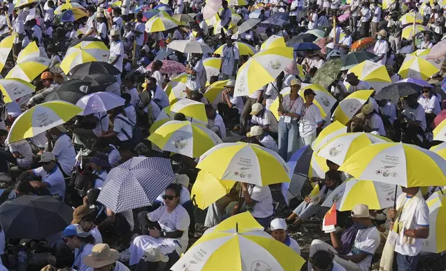 Faithful attend the holy mass lead by Pope Francis at Tasitolu park in Dili, East Timor, Tuesday, Sept. 10, 2024. (AP Photo/Dita Alangkara, Pool)