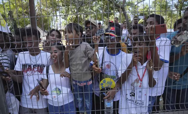 People wait for Pope Francis' arrival at Dili Presidente Nicolau Lobato International Airport in Dili, East Timor, Monday, Sept. 9, 2024. (AP Photo/Dita Alangkara)