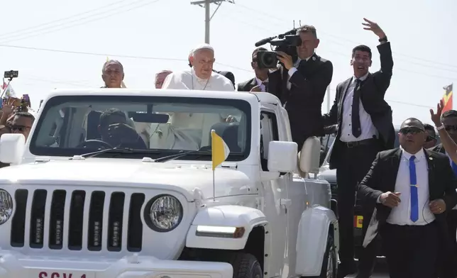 Pope Francis in a car, is welcomed in Dili, East Timor, Monday, Sept. 9, 2024. (AP Photo/Firdia Lisnawati)