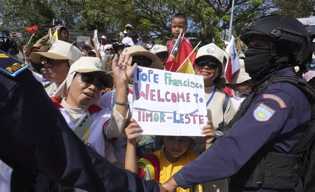 A child holds a welcome sign for Pope Francis in Dili, East Timor, Monday, Sept. 9, 2024. (AP Photo/Firdia Lisnawati)