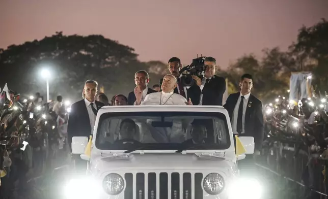 Pope Francis waves from the popemobile as he tours the crowd of faithful at the end of a mass at the seaside park of Tasitolu, 8 kilometers west of Dili, East Timor, Tuesday, Sept. 10, 2024. (Alessandro Di Meo/pool via AP)