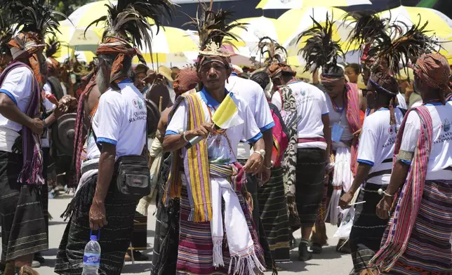 East Timorese wearing traditional dresses wait for Pope Francis' arrival outside of the Dili Presidente Nicolau Lobato International Airport in Dili, East Timor, Monday, Sept. 9, 2024. (AP Photo/Firdia Lisnawati)