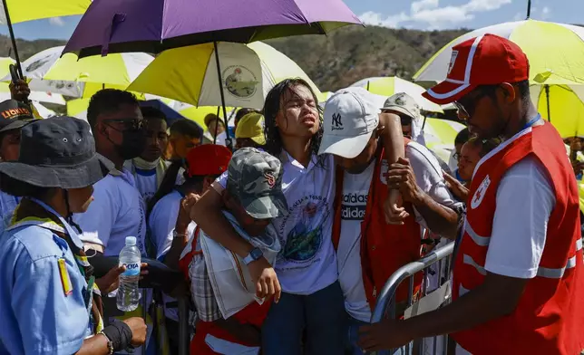 Medical workers carry a person as Catholic faithful gather to attend a Holy Mass that will be presided by Pope Francis at the Esplanade of Taci Tolu in Dili, East Timor, Tuesday, Sept.10, 2024. (Willy Kurniawan/Pool Photo via AP)