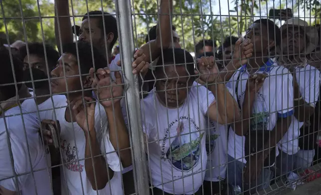 People wait for Pope Francis' arrival at Dili Presidente Nicolau Lobato International Airport in Dili, East Timor, Monday, Sept. 9, 2024. (AP Photo/Dita Alangkara)