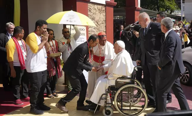 Pope Francis is welcomed during the meeting with young people in Centro de Convencoes in Dili, East Timor, Wednesday, Sept. 11, 2024. (AP Photo/Firdia Lisnawati)