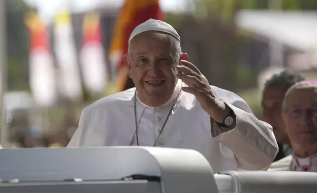 Pope Francis gestures from the car, in Dili, East Timor, Monday, Sept. 9, 2024. (AP Photo/Dita Alangkara)