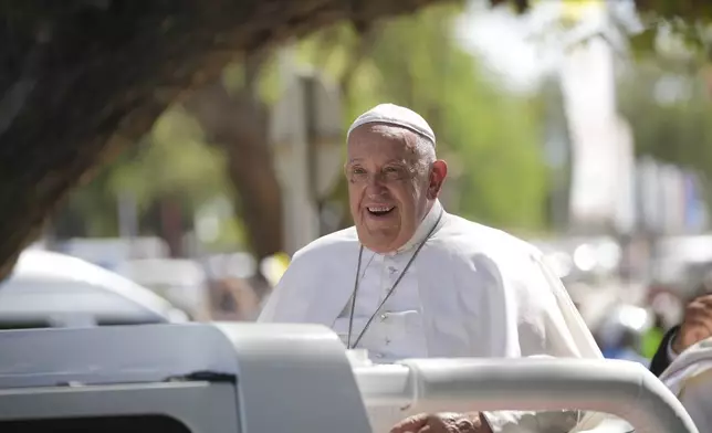 Pope Francis in the car, is welcomed in Dili, East Timor, Monday, Sept. 9, 2024. (AP Photo/Dita Alangkara)