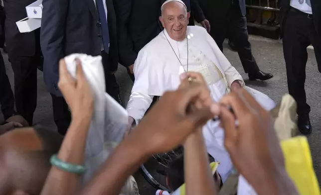 Pope Francis greets the people after the holy mass at the Cathedral of the Immaculate Conception in Dili, East Timor, Tuesday, Sept. 10, 2024. (AP Photo/Dita Alangkara)