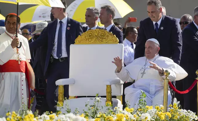 Archbishop of Dili Cardinal Virgilio do Carmo da Silva, left, welcomes Pope Francis as he arrives to preside over a mass in Tasitolu, some 8 kilometers west of Dili, East Timor, Tuesday, Sept. 10, 2024. Pope Francis presides over a mass in a seaside park on the same field where St. John Paul II celebrated a historic liturgy during East Timor's fight for independence from Indonesian rule. (AP Photo/Gregorio Borgia)