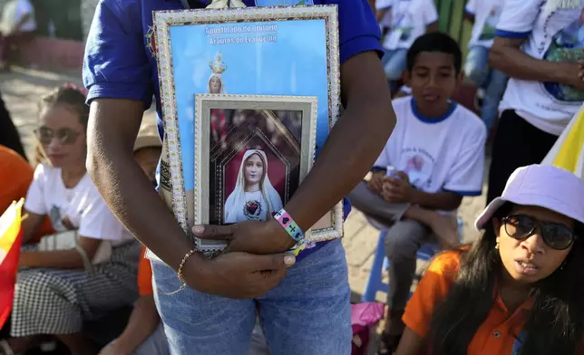 People wait for Pope Francis visiting to children with disabilities of the Irmas Alma School in Dili, East Timor, Tuesday, Sept. 10, 2024. (AP Photo/Dita Alangkara)