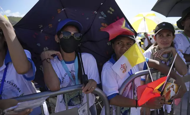 East Timorese wait at Tacitolu park for Pope Francis' Mass in Dili, East Timor, Tuesday, Sept. 10, 2024. (AP Photo/Dita Alangkara)