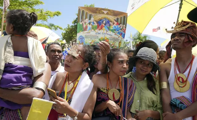 People wait for Pope Francis near the Cathedral of the Immaculate Conception in Dili, East Timor, Tuesday, Sept. 10, 2024. (AP Photo/Firdia Lisnawati)