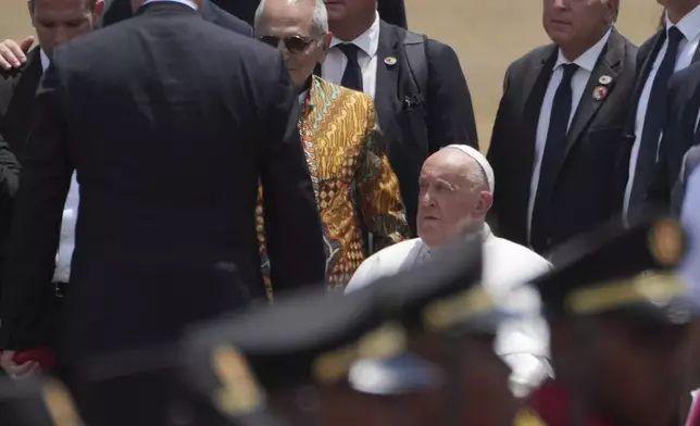 Pope Francis is accompanied by East Timor's President Jose Ramos-Horta to abroad a plane to Singapore at Nicolau Lobato International Airport in Dili, East Timor, Wednesday, Sept. 11, 2024. (AP Photo/Dita Alangkara)