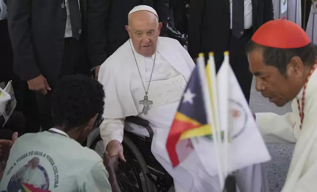 Pope Francis greets the people after the holy mass at the Cathedral of the Immaculate Conception in Dili, East Timor, Tuesday, Sept. 10, 2024. (AP Photo/Dita Alangkara)