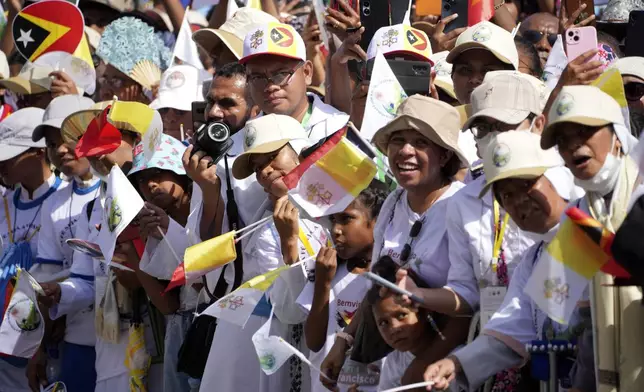 People wait for Pope Francis' arrival outside of the Dili Presidente Nicolau Lobato International Airport in Dili, East Timor, Monday, Sept. 9, 2024. (AP Photo/Firdia Lisnawati)