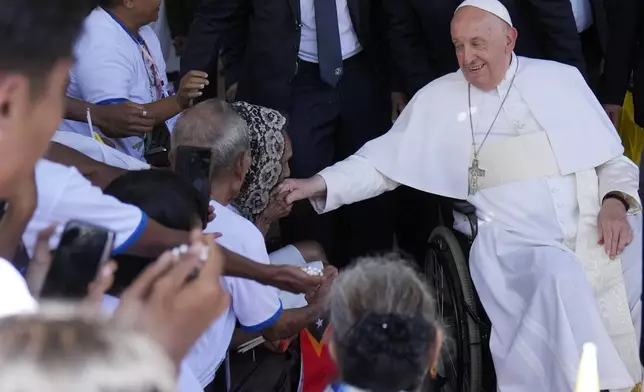 Pope Francis greets the people after the holy mass at the Cathedral of the Immaculate Conception in Dili, East Timor, Tuesday, Sept. 10, 2024. (AP Photo/Dita Alangkara)