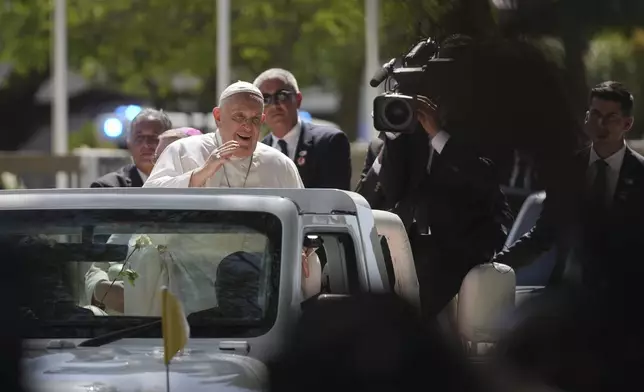 Pope Francis waves from the car, in Dili, East Timor, Monday, Sept. 9, 2024. (AP Photo/Dita Alangkara)