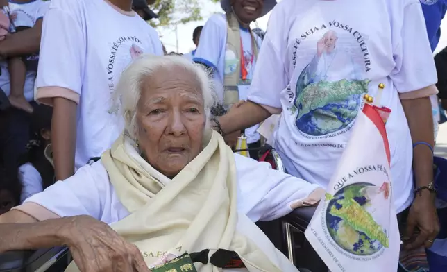 People wait Pope Francis' arrival outside of the Dili Presidente Nicolau Lobato International Airport in Dili, East Timor, Monday, Sept. 9, 2024. (AP Photo/Firdia Lisnawati)