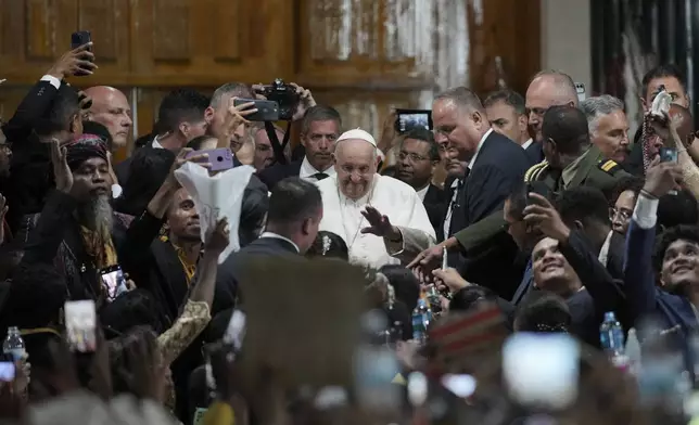 Pope Francis gestures as he is surrounded by attendees after a meeting at the Presidential Palace in Dili, East Timor, Monday, Sept. 9, 2024. (AP Photo/Dita Alangkara)