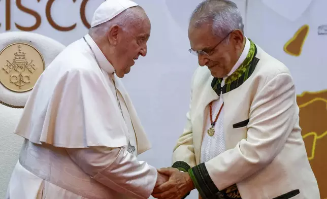 East Timor President Jose Ramos-Horta, right, shakes hands with Pope Francis during a meeting with East Timor authorities, civil society, and the diplomatic corps at the Presidential Palace in Dili, East Timor, Monday, Sept. 9, 2024. (Willy Kurniawan/Pool Photo via AP)