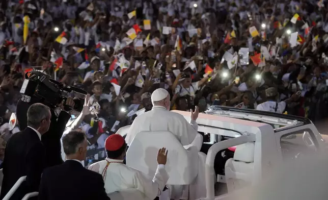 Pope Francis gestures as he leaves after leading a holy mass at Tasitolu park in Dili, East Timor, Tuesday, Sept. 10, 2024. (AP Photo/Dita Alangkara, Pool)