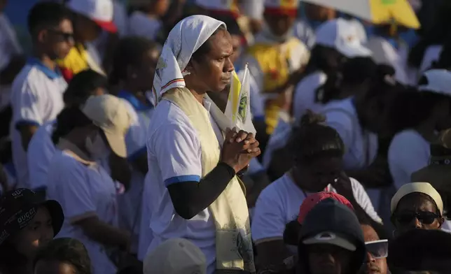 A faithful attends the holy mass lead by Pope Francis at Tasitolu park in Dili, East Timor, Tuesday, Sept. 10, 2024. (AP Photo/Dita Alangkara, Pool)