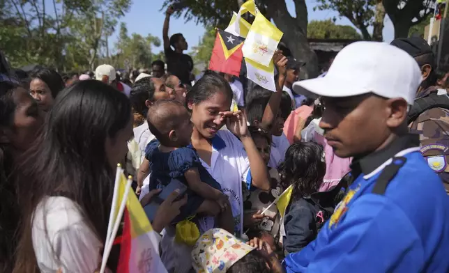 East Timorese women weep after Pope Francis's motorcade passes by in Dili, East Timor, Monday, Sept. 9, 2024. (AP Photo/Dita Alangkara)