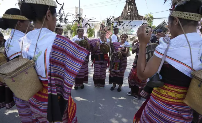 Women with traditional dress prepare to welcome Pope Francis' visit in Dili, East Timor Monday, Sept. 9, 2024. (AP Photo/Firdia Lisnawati)