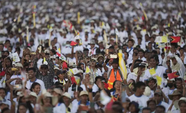 Faithful react during the holy mass lead by Pope Francis at Tasitolu park in Dili, East Timor, Tuesday, Sept. 10, 2024. (AP Photo/Dita Alangkara, Pool)