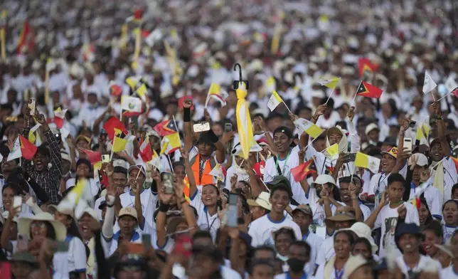 Faithful react during the holy mass lead by Pope Francis at Tasitolu park in Dili, East Timor, Tuesday, Sept. 10, 2024. (AP Photo/Dita Alangkara, Pool)