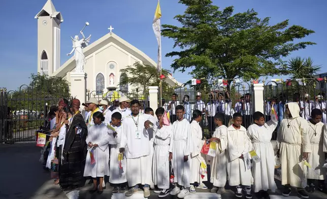 Catholic faithful wait for Pope Francis to arrive at the Cathedral of the Immaculate Conception in Dili, East Timor, Tuesday, Sept. 10, 2024. (AP Photo/Firdia Lisnawati)