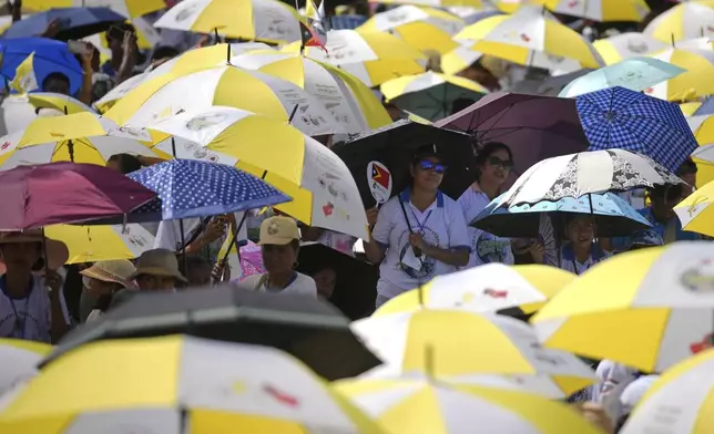 East Timorese wait at Tacitolu park for Pope Francis' Mass in Dili, East Timor, Tuesday, Sept. 10, 2024. (AP Photo/Dita Alangkara)