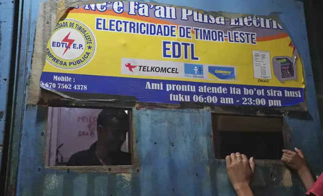 A man sells electricity credit at a shop in Dili, East Timor Sunday, Sept. 8, 2024. (AP Photo/Firdia Lisnawati)