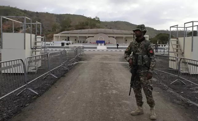 A security officer stands guard in Tasitolu, an open field on the coast which will be the venue of a papal Mass, in Dili, East Timor, Thursday, Sept. 5, 2024. (AP Photo/Firdia Lisnawati)