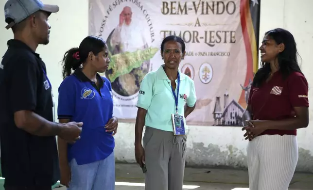 Veteran journalist Suzana Cardoso, second right, speaks with her colleagues at a media center in Dili, East Timor on Saturday, Sept. 7, 2024. (AP Photo/Firdia Lisnawati)