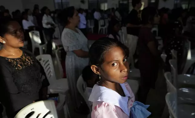 A girl attends Sunday mass at a church In Dili, East Timor, Sunday, Aug. 11, 2024. (AP Photo/Achmad Ibrahim)