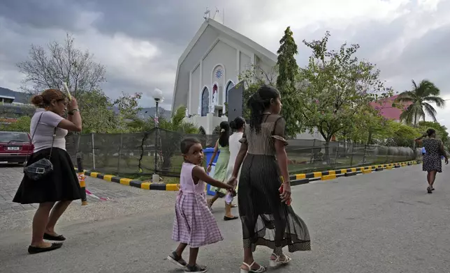 Parishioners arrive to attend a mass at the Immaculate Conception Cathedral in Dili, East Timor, Sunday, Aug. 11, 2024. (AP Photo/Achmad Ibrahim)