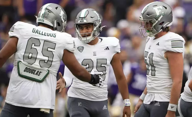 Eastern Michigan place kicker Jesús Gómez, center, is greeted by teammates, including offensive lineman Nicholas Gallegos (65) after making a field goal against Washington during the first half of an NCAA college football game Saturday, Sept. 7, 2024, in Seattle. (AP Photo/Lindsey Wasson)