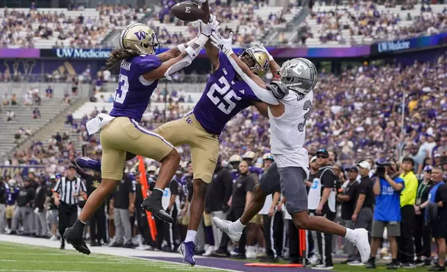 Washington safety Kamren Fabiculanan (13) nearly intercepts the ball with cornerback Elijah Jackson (25) on a pass to Eastern Michigan wide receiver Terry Lockett Jr. (3) in the end zone during the second half of an NCAA college football game Saturday, Sept. 7, 2024, in Seattle. Washington won 30-9. (AP Photo/Lindsey Wasson)