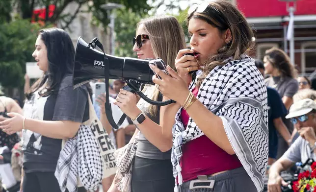 Alia Amanpour Trapp, right, talks to the crowd during a pro-Palestine rally and march on Temple University campus in Philadelphia, Aug. 29, 2024. (AP Photo/Chris Szagola)