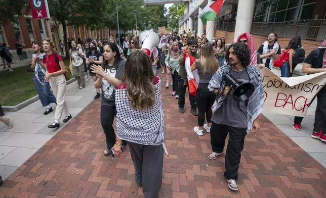 Alia Amanpour Trapp, center, leads the crowd during a pro-Palestine rally and march on Temple University campus in Philadelphia, Aug. 29, 2024. (AP Photo/Chris Szagola)