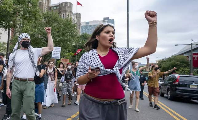 Alia Amanpour Trapp, center, reacts to car horns as she leads the crowd during a pro-Palestine rally and march on Temple University campus in Philadelphia, Aug. 29, 2024. (AP Photo/Chris Szagola)