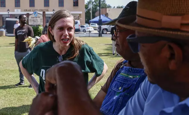 Alabama's new 2nd Congressional District Republican candidate Caroleene Dobson talks with voters during the Macon County Day Festival in Tuskegee, Ala., on Saturday, Aug 31, 2024. (AP Photo/ Butch Dill)